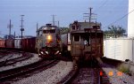 SBD 8334 leads a southbound train past thd caboose on a northbound piggyback train